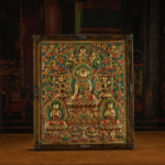 1 RADIANCE OF COMPASSION – 19TH CENTURY GILT COPPER JOWO BUDDHA WALL THANGKA